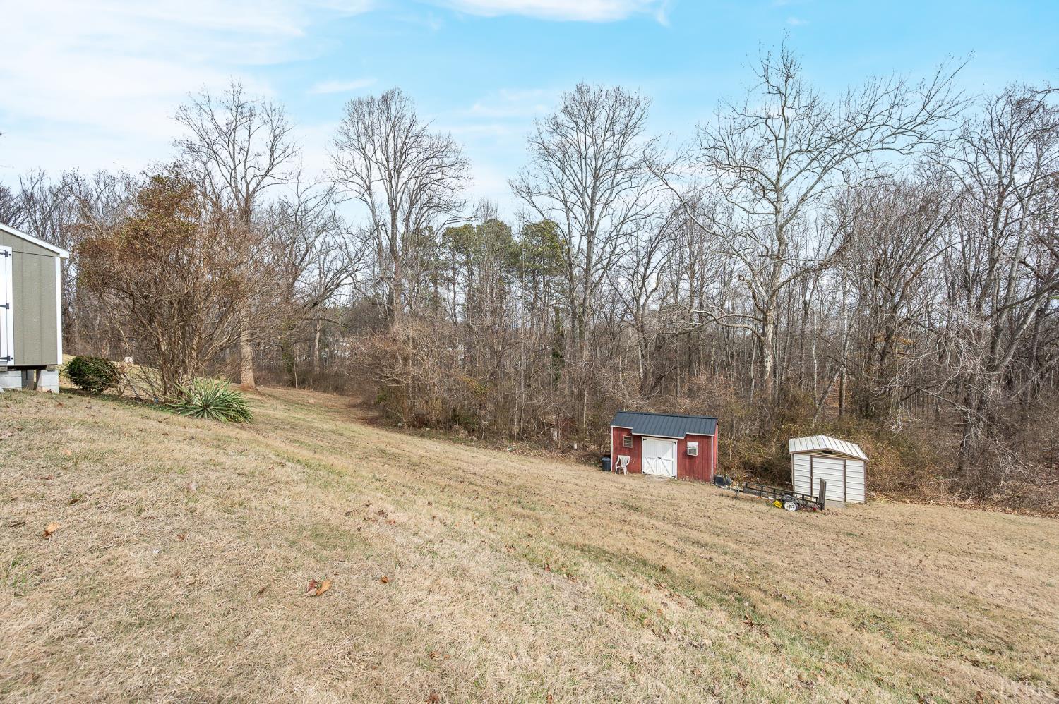 129 Greendale Drive Rustburg, VA 24588 - Photo 32 of 35 a street view with large trees