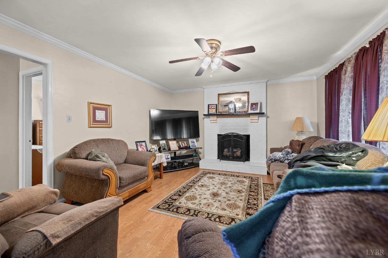 129 Greendale Drive Rustburg, VA 24588 - Photo 7 of 35 a living room with furniture or couch and a fireplace