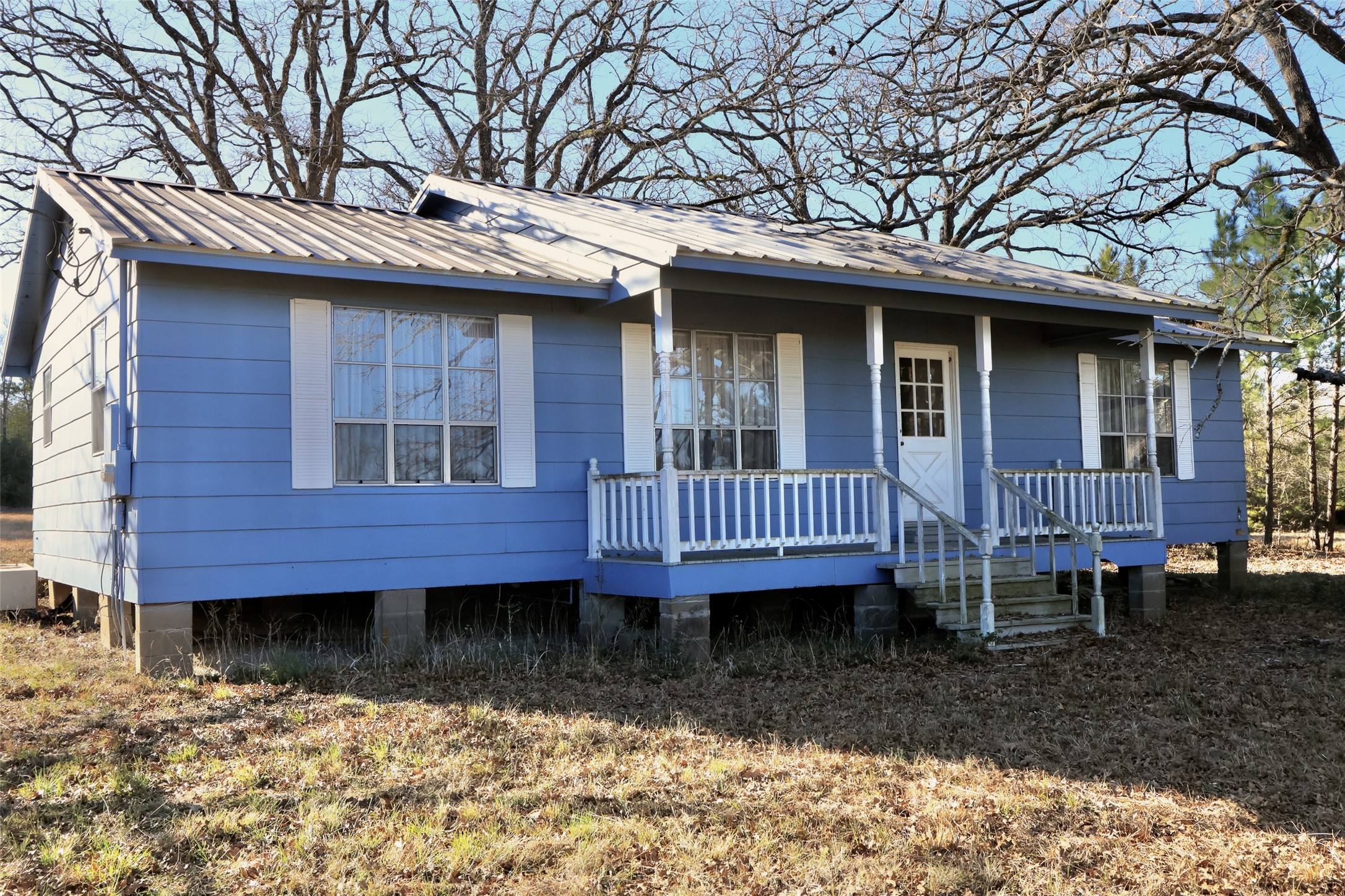 10173 Deer Ridge Road Bedias, TX 77831 - Photo 31 of 46 a view of a house with a yard and wooden deck