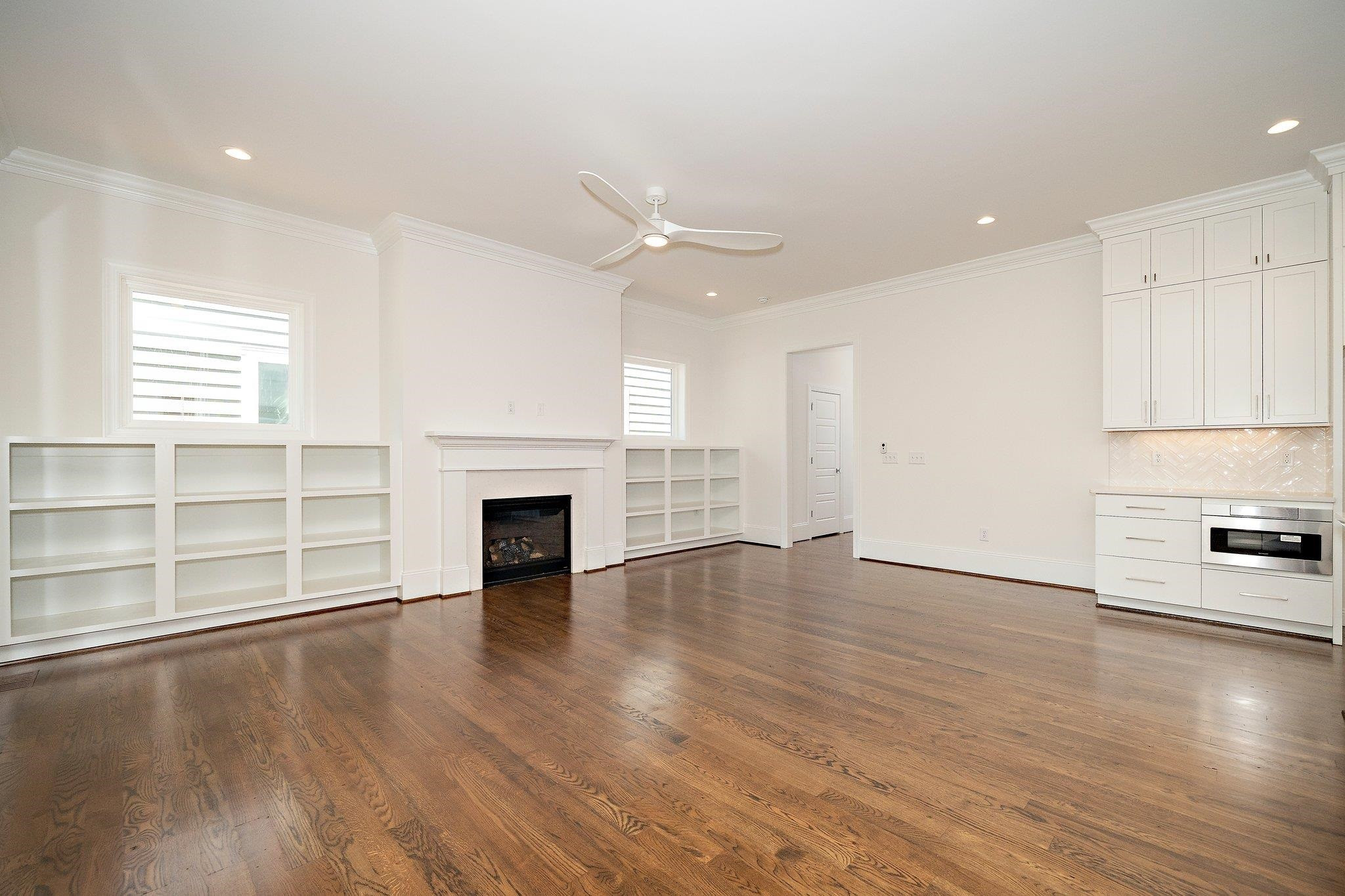 1809 Fairview Road Raleigh, NC 27608 - Photo 17 of 37 an empty room with wooden floor fireplace and windows