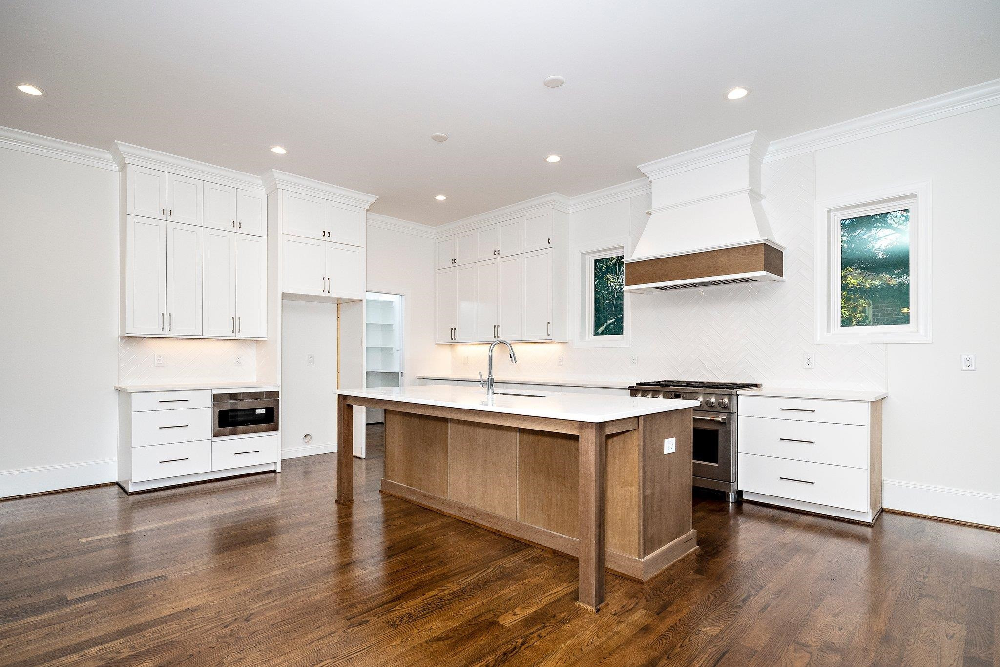 1809 Fairview Road Raleigh, NC 27608 - Photo 20 of 37 a kitchen with stainless steel appliances a sink stove and wooden floor