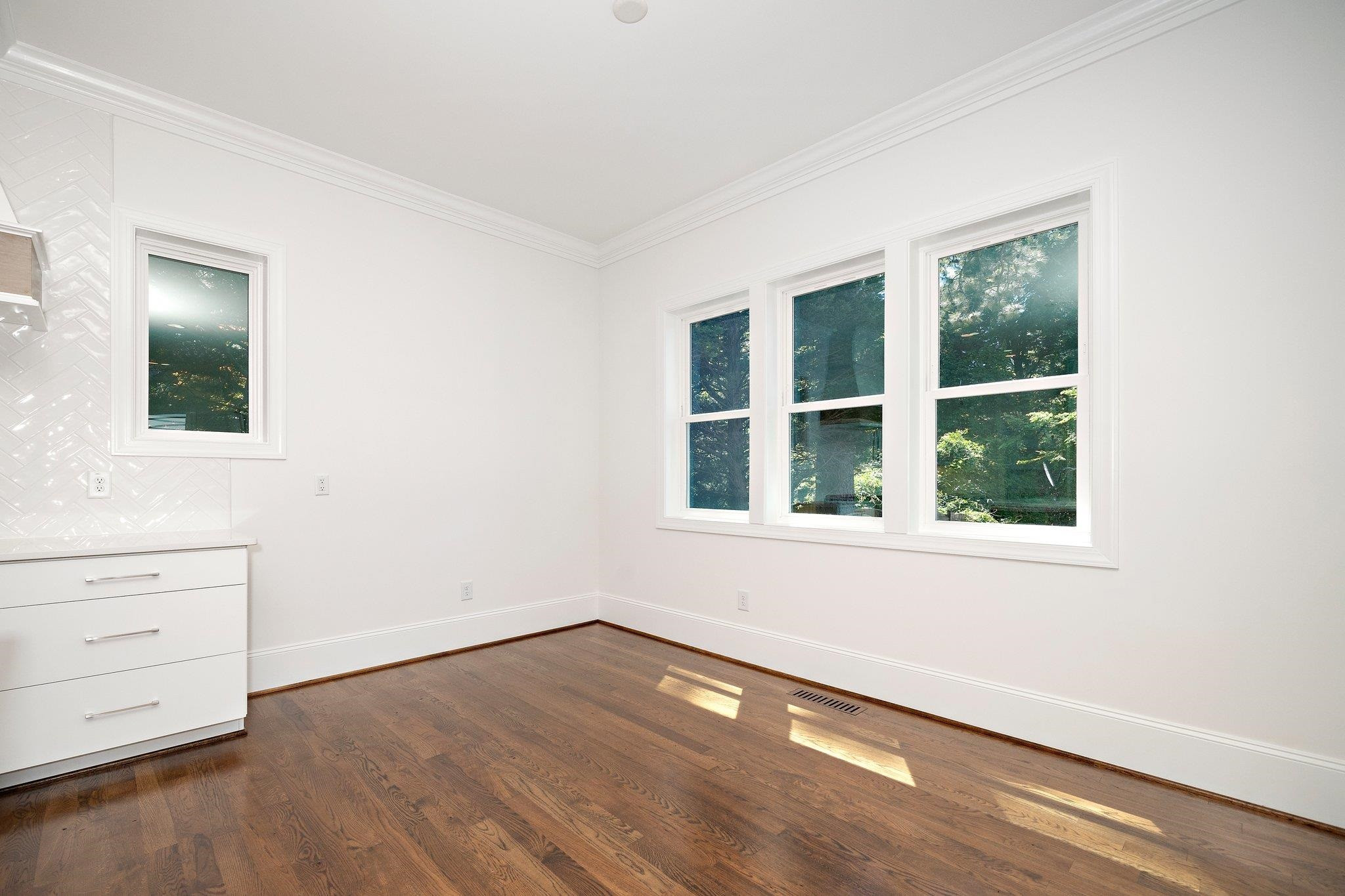 1809 Fairview Road Raleigh, NC 27608 - Photo 21 of 37 an empty room with wooden floor and window