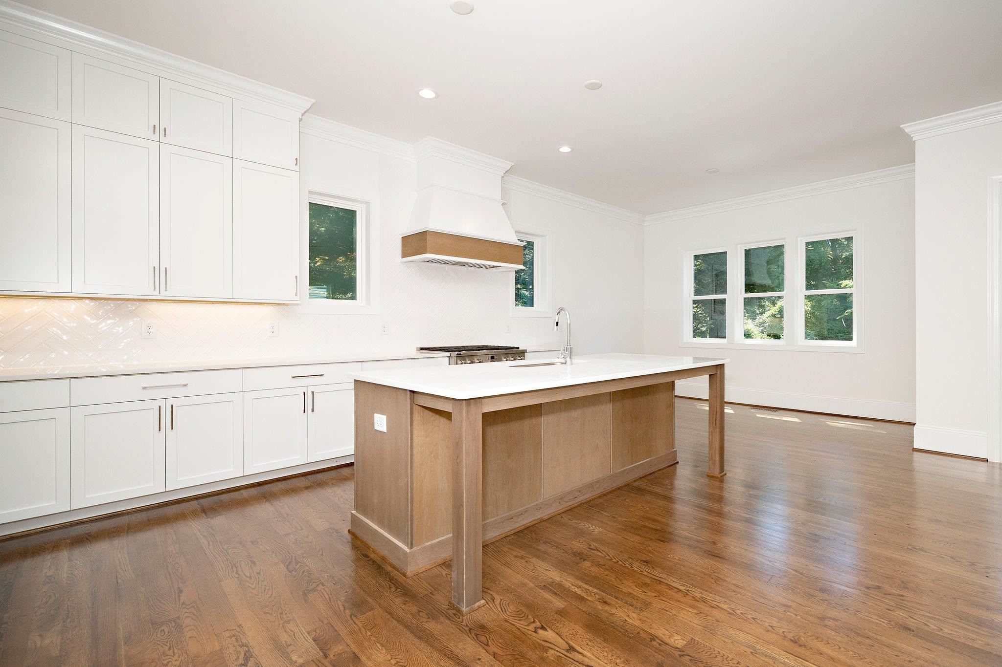 1809 Fairview Road Raleigh, NC 27608 - Photo 23 of 37 a kitchen with white cabinets and sink