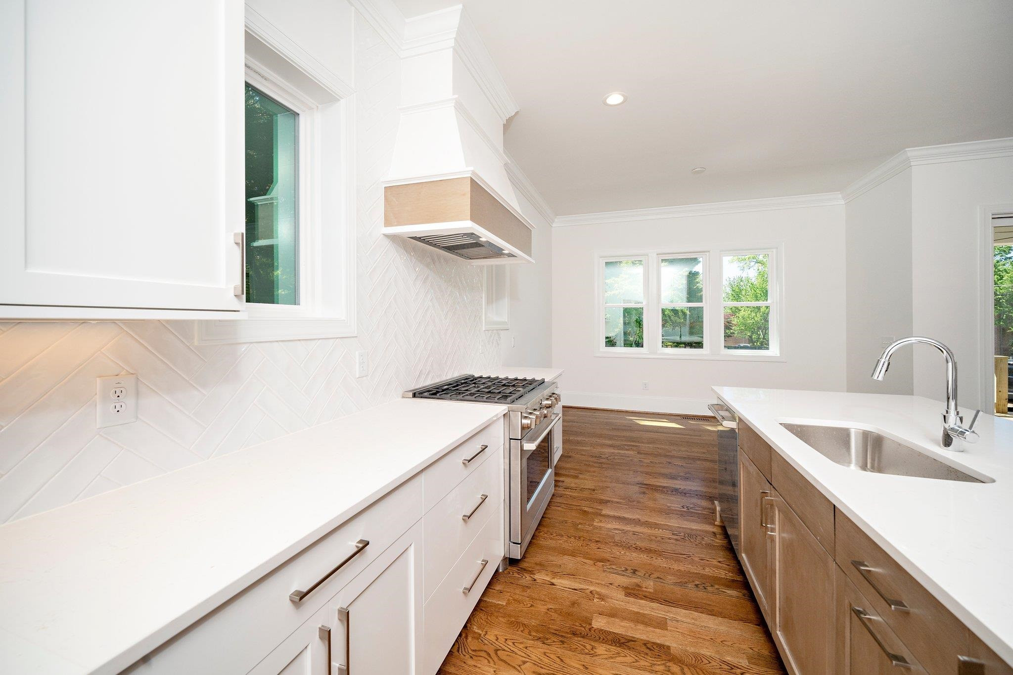 1809 Fairview Road Raleigh, NC 27608 - Photo 25 of 37 a kitchen with a sink and large window