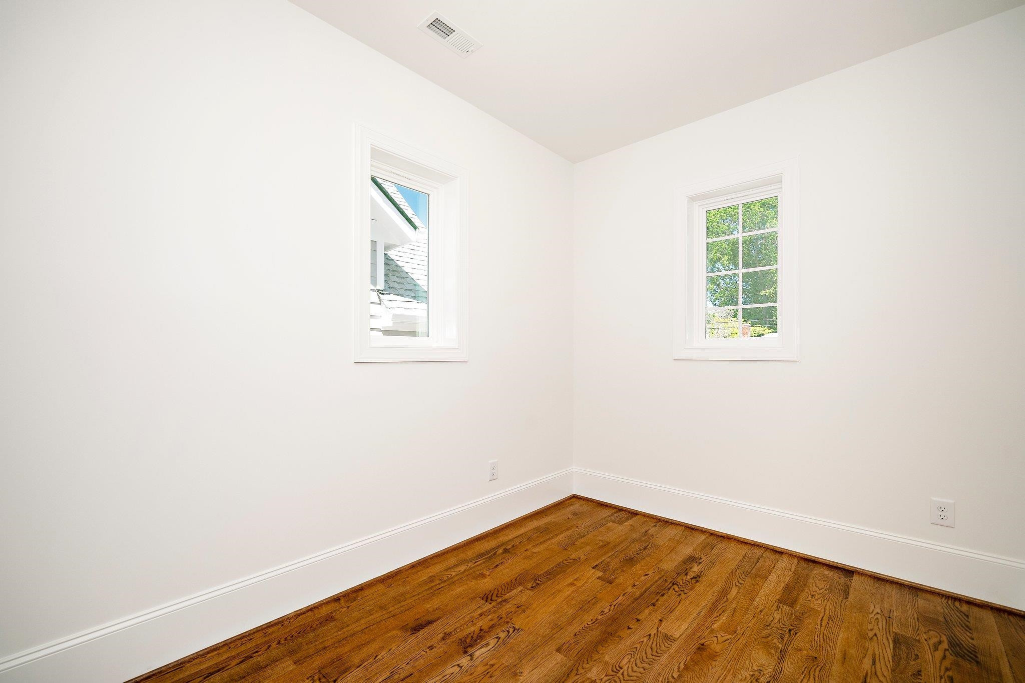 1809 Fairview Road Raleigh, NC 27608 - Photo 26 of 37 an empty room with wooden floor and windows