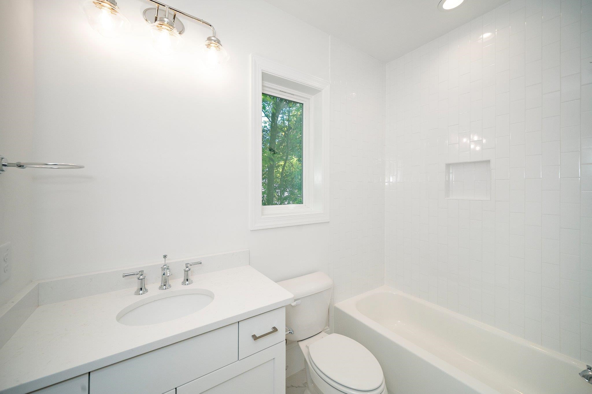 1809 Fairview Road Raleigh, NC 27608 - Photo 28 of 37 a bathroom with a sink toilet a bathtub and vanity