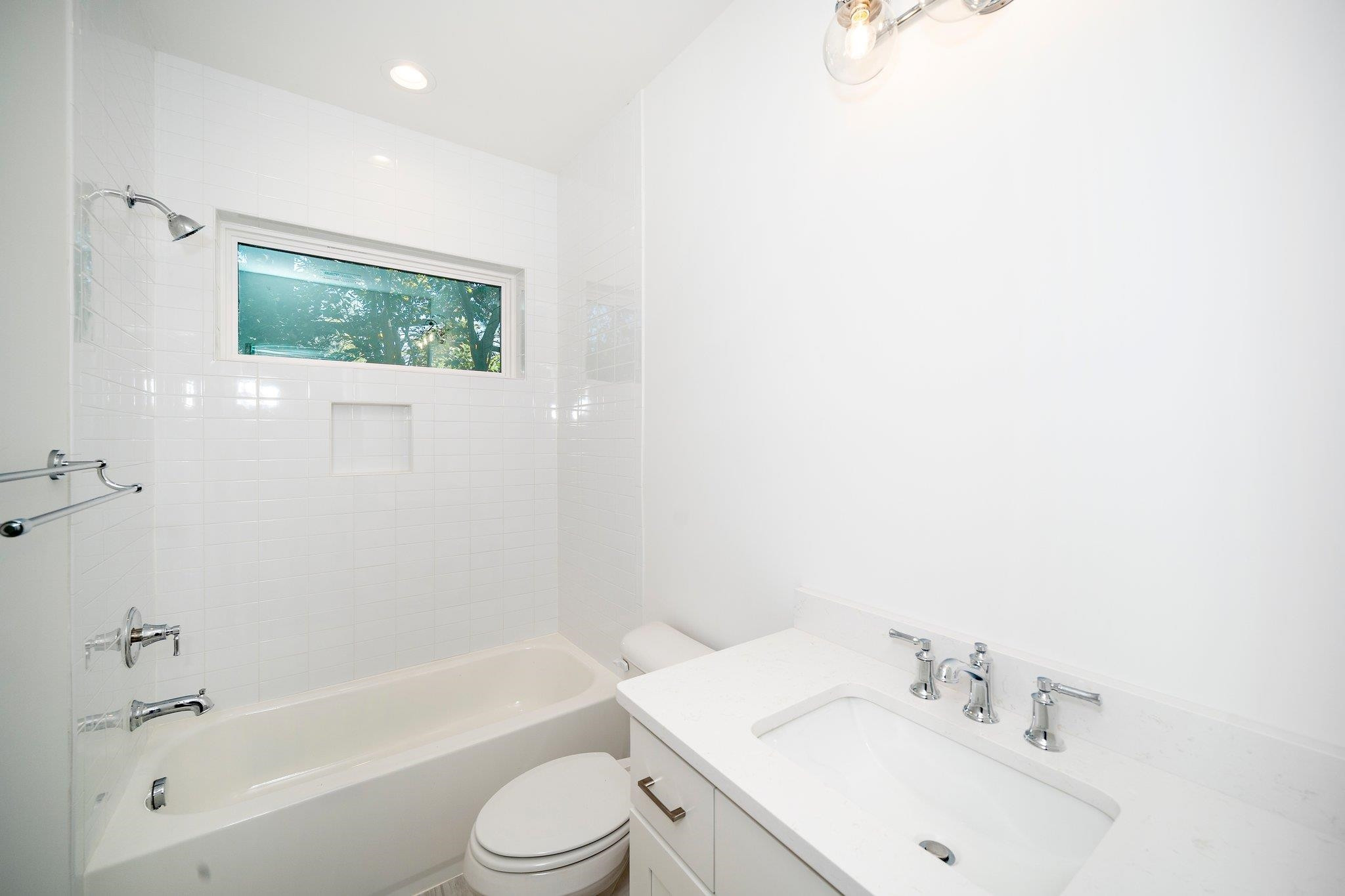 1809 Fairview Road Raleigh, NC 27608 - Photo 31 of 37 a bathroom with a bathtub shower sink vanity and toilet