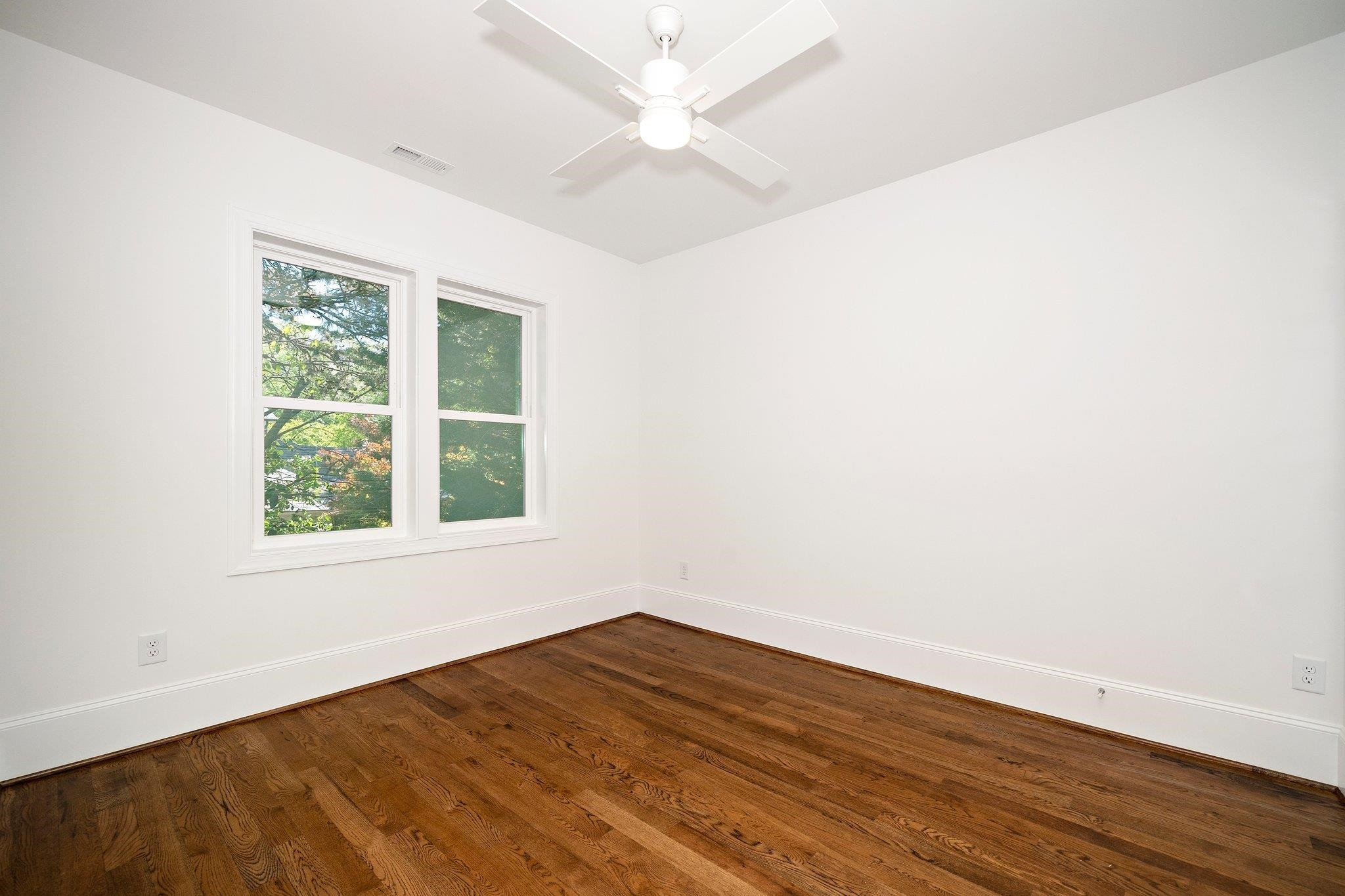 1809 Fairview Road Raleigh, NC 27608 - Photo 32 of 37 an empty room with wooden floor and windows