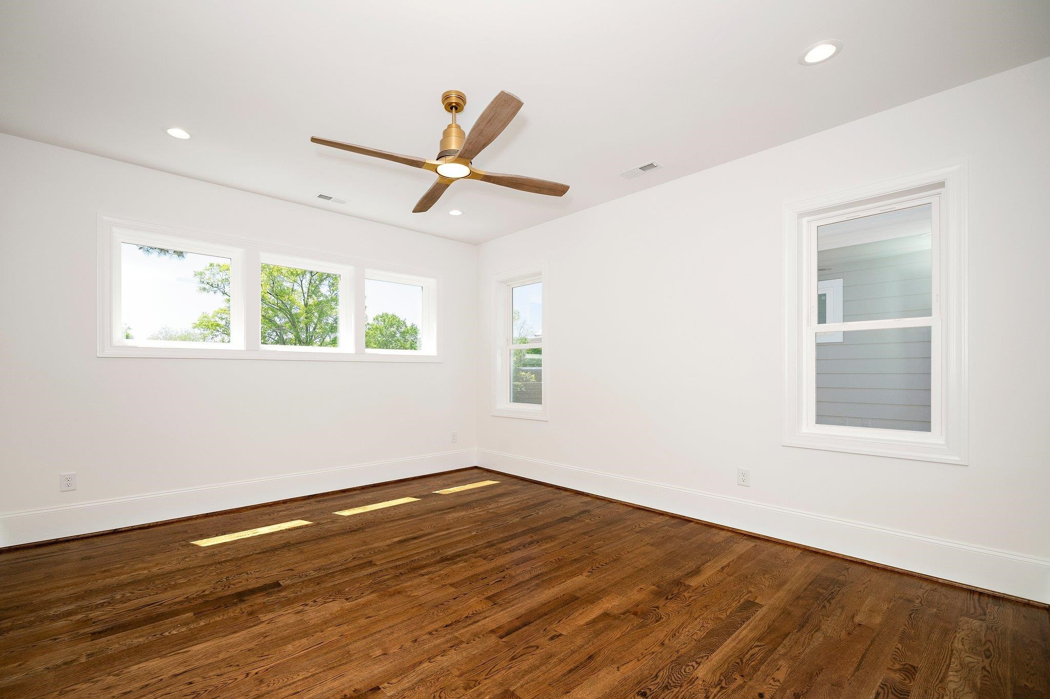 1809 Fairview Road Raleigh, NC 27608 - Photo 34 of 37 a view of empty room with wooden floor and fan