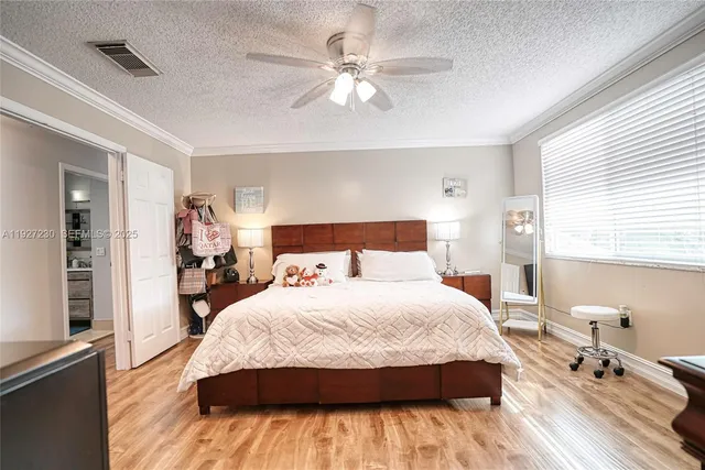 a spacious bedroom with a bed and a chandelier