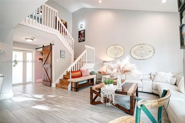 a living room with furniture a rug and a clock