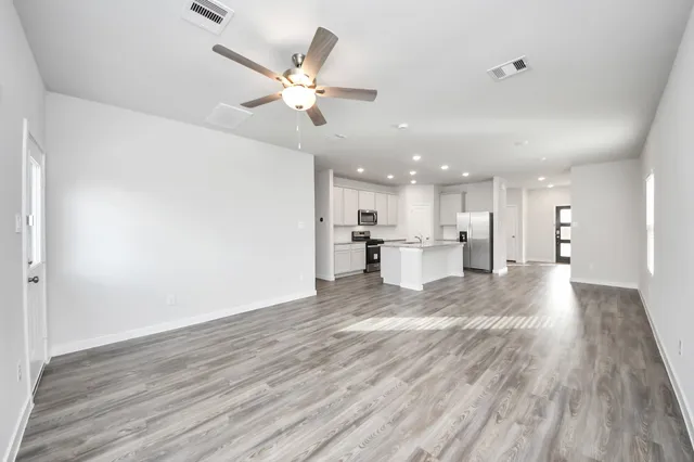 a view of a kitchen with a sink and a refrigerator