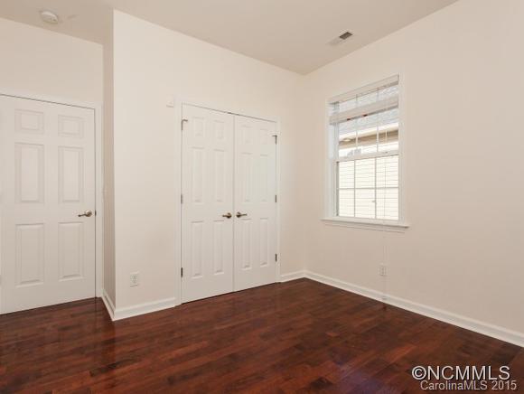 127 Pamlico Road Fletcher, NC 28732 - Photo 14 of 22 an empty room with wooden floor and windows