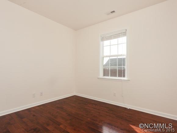 127 Pamlico Road Fletcher, NC 28732 - Photo 15 of 22 an empty room with wooden floor and windows
