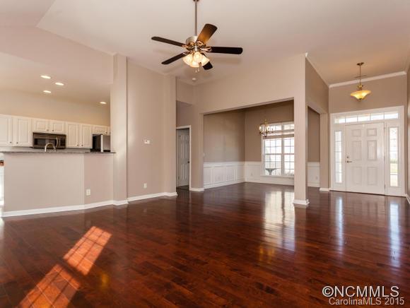 127 Pamlico Road Fletcher, NC 28732 - Photo 3 of 22 a view of an empty room with wooden floor and a kitchen