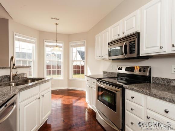 127 Pamlico Road Fletcher, NC 28732 - Photo 4 of 22 a kitchen with stainless steel appliances granite countertop a stove a sink and a microwave