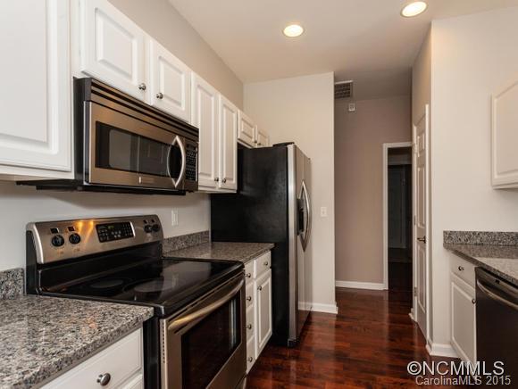 127 Pamlico Road Fletcher, NC 28732 - Photo 5 of 22 a kitchen with stainless steel appliances granite countertop a stove microwave and refrigerator