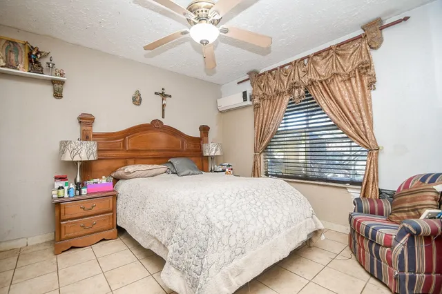 a bedroom with bed and window