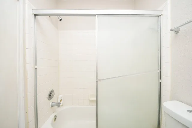 a bathroom with a shower and a bath tub
