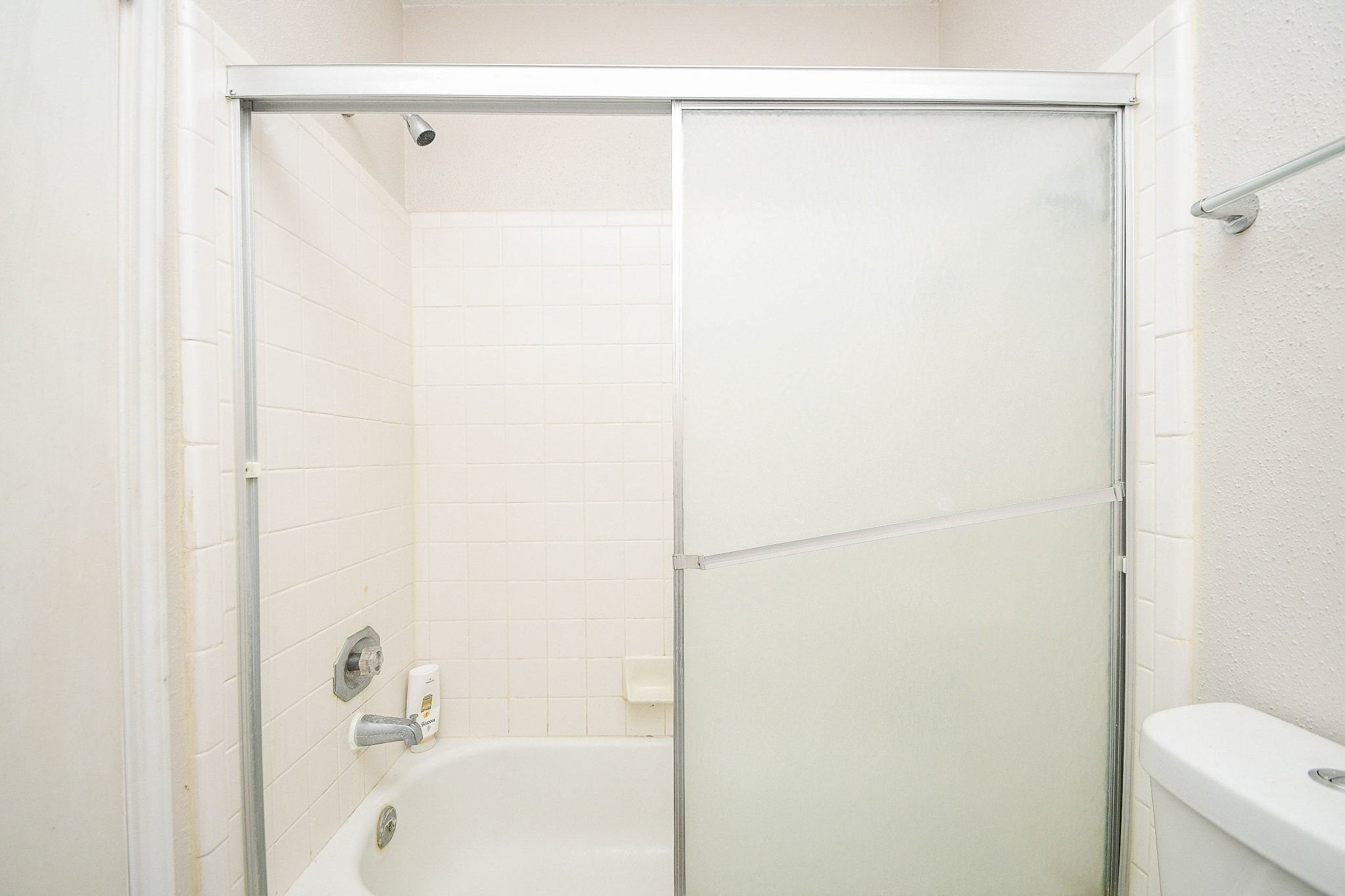 11004 Rustling Winds Drive Houston, TX 77064 - Photo 18 of 20 a bathroom with a shower and a bath tub