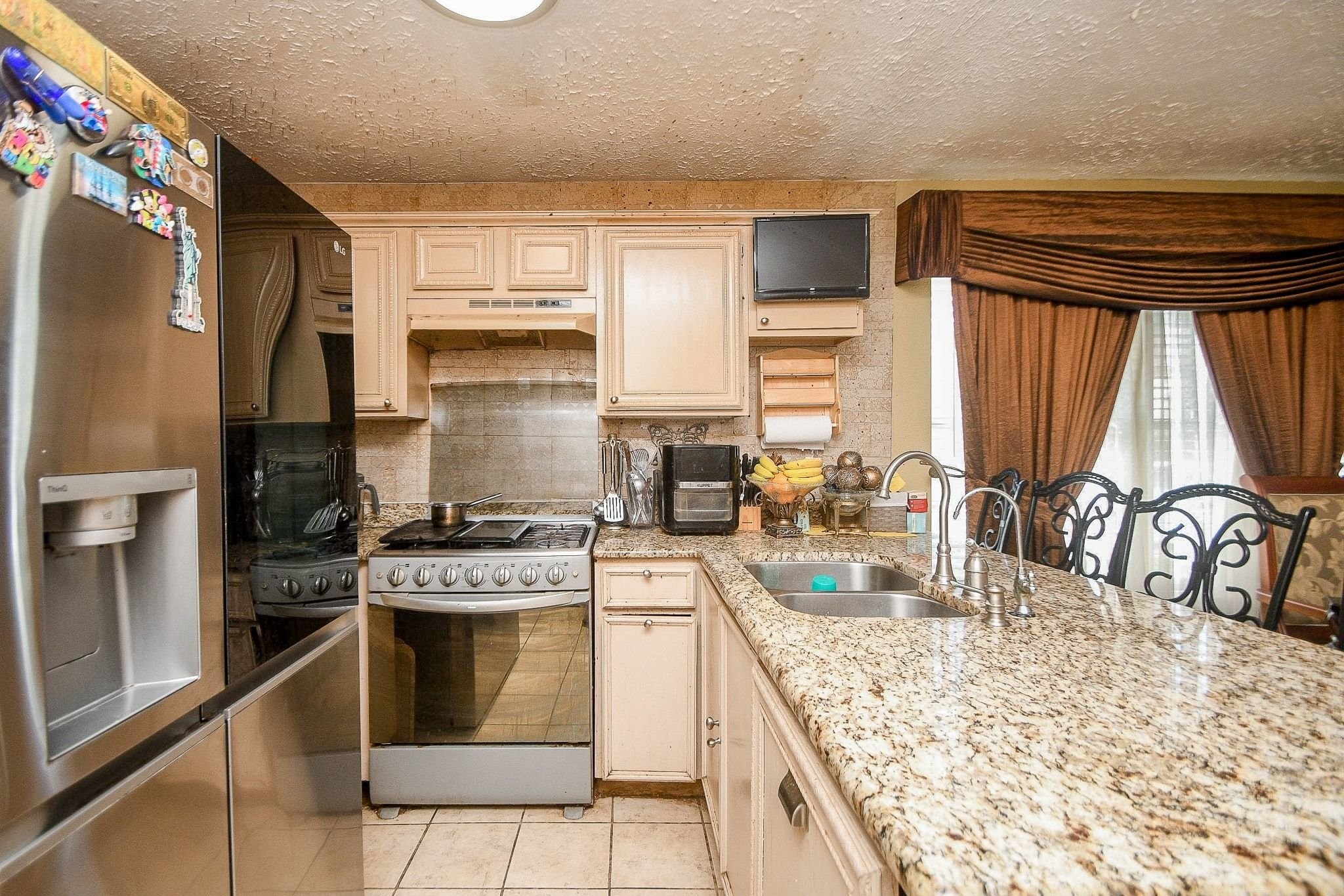 11004 Rustling Winds Drive Houston, TX 77064 - Photo 8 of 20 a kitchen with stainless steel appliances granite countertop a stove a sink and a refrigerator