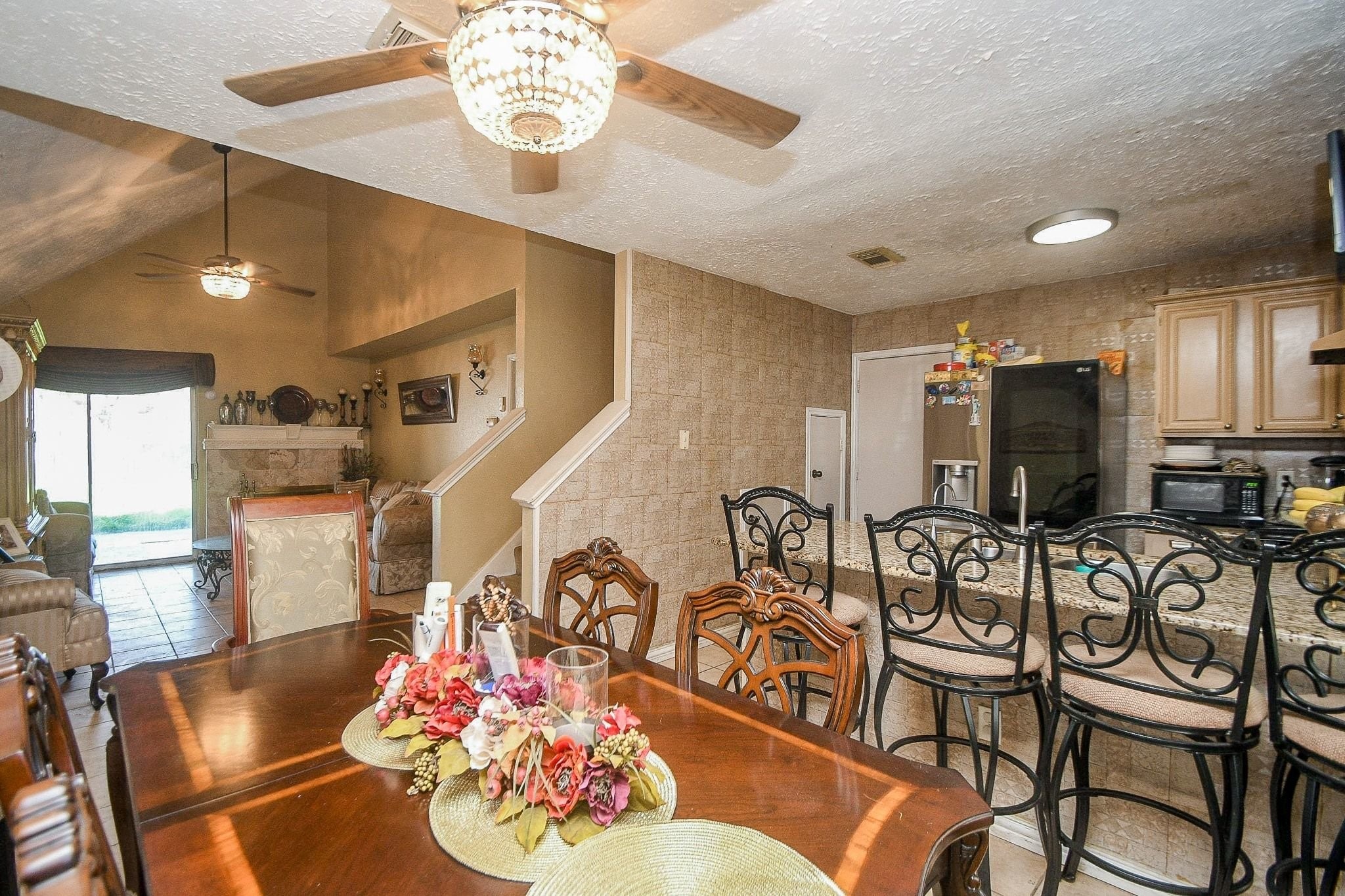 11004 Rustling Winds Drive Houston, TX 77064 - Photo 9 of 20 a view of a dining room with furniture a chandelier and wooden floor