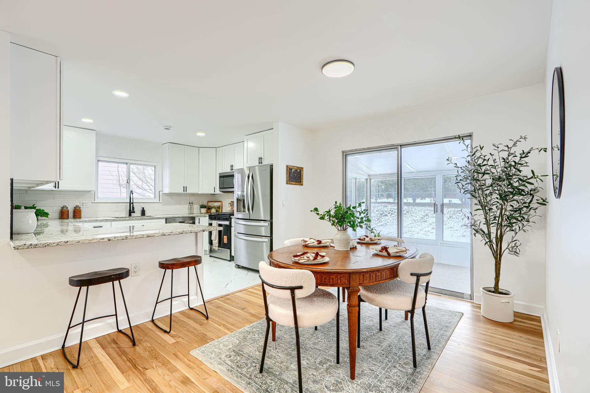 6112 Chesworth Road Baltimore, MD 21228 - Photo 15 of 47 a dining room with furniture and a floor to ceiling window