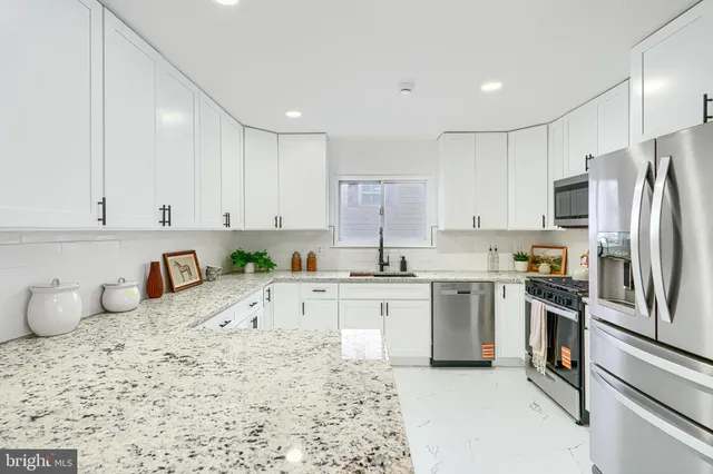 a kitchen with a sink stove and refrigerator