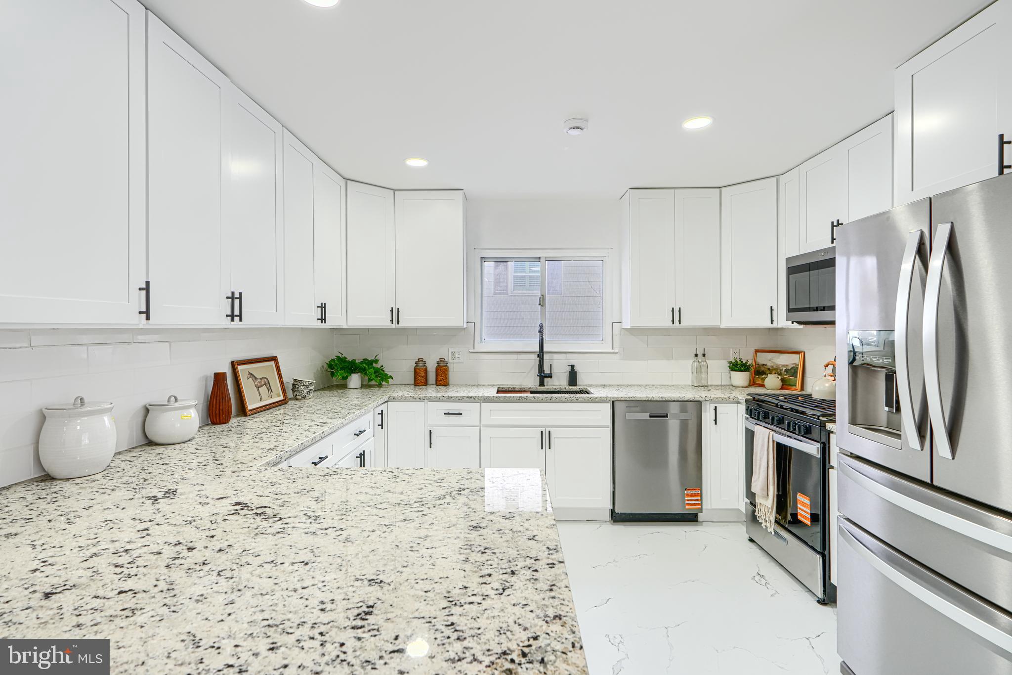 6112 Chesworth Road Baltimore, MD 21228 - Photo 19 of 47 a kitchen with a sink stove and refrigerator