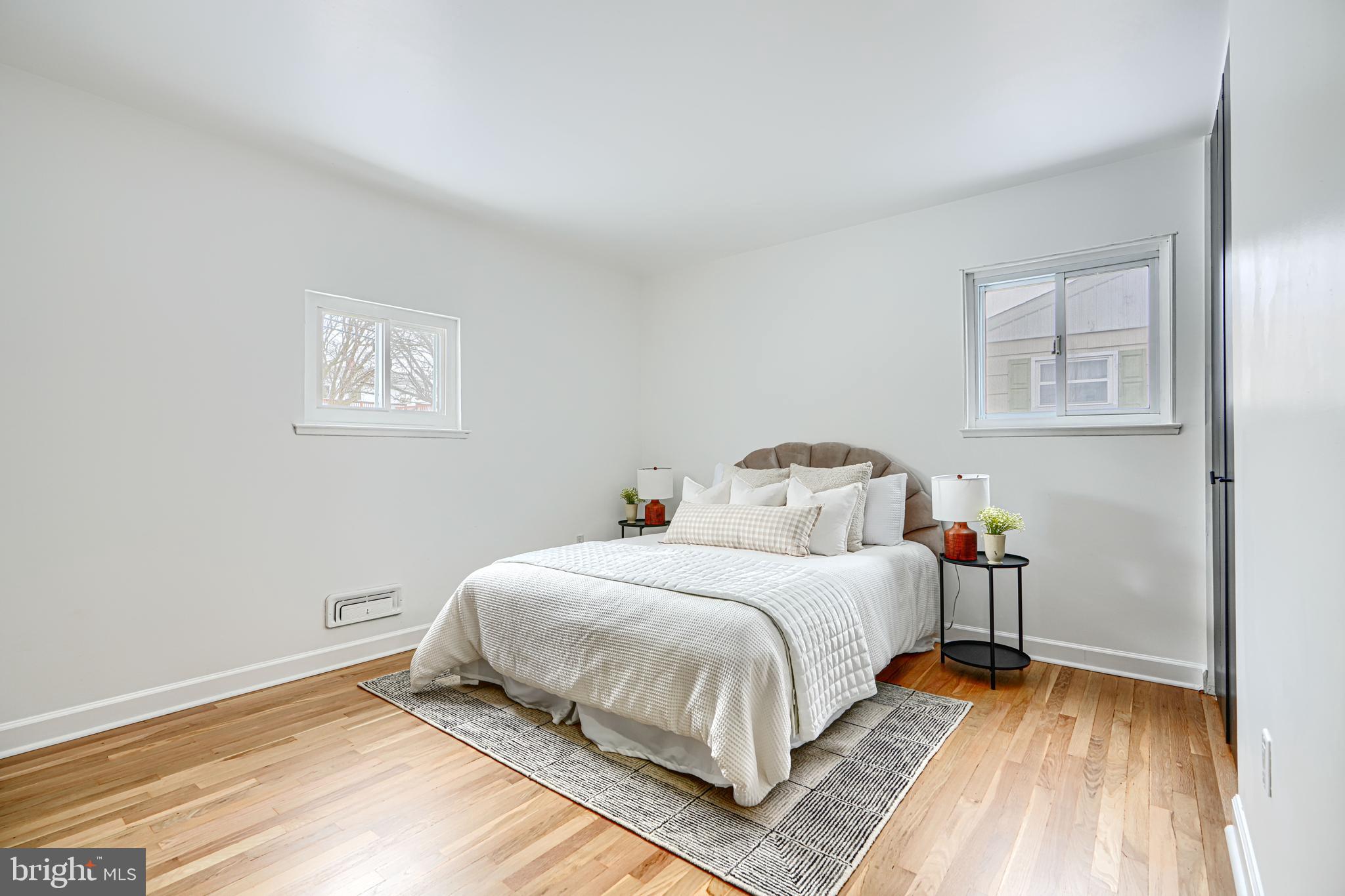 6112 Chesworth Road Baltimore, MD 21228 - Photo 30 of 47 a bedroom with a bed and wooden floor