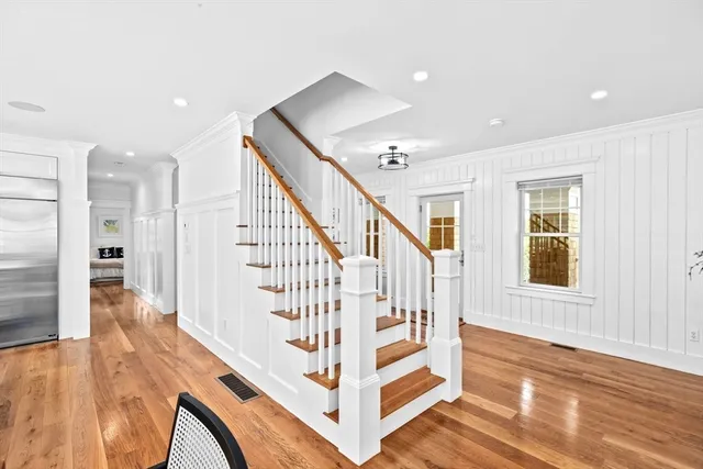 a view of entryway and hall with wooden floor
