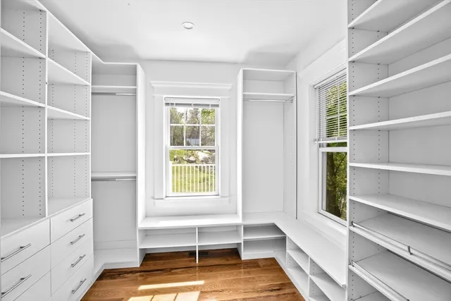 a view of walk in closet with empty racks