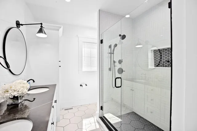 a bathroom with a granite countertop sink toilet and shower
