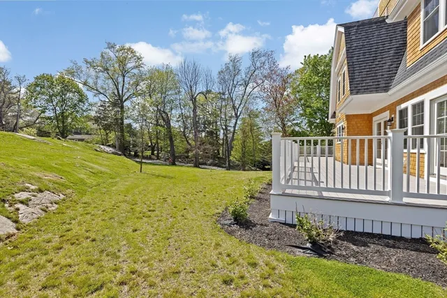 a view of a house with a large window and wooden fence