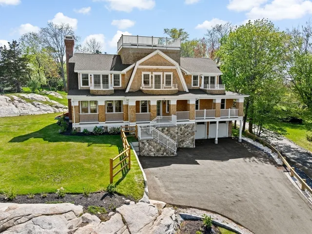 a bedroom with a balcony a bed and a large window