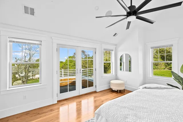 a bedroom with a bed couch and a window