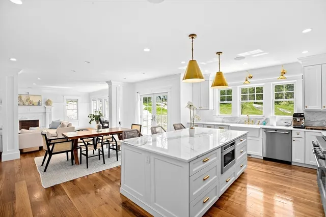 a large white kitchen with a large window