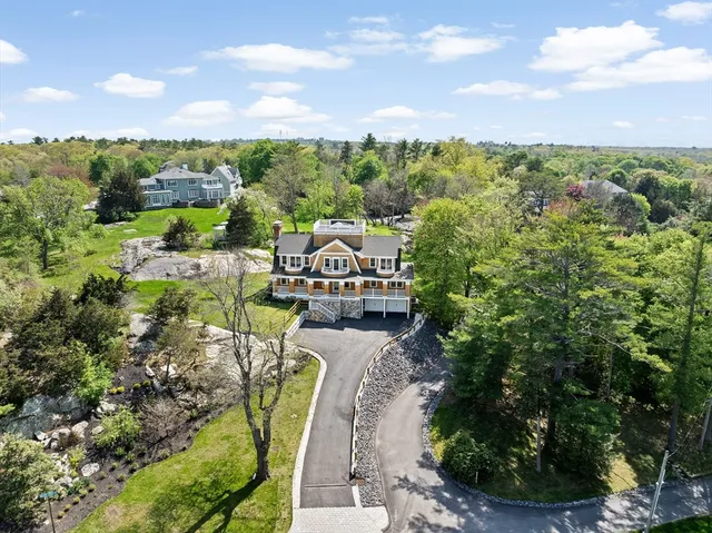 a view of a city with lawn chairs and large trees