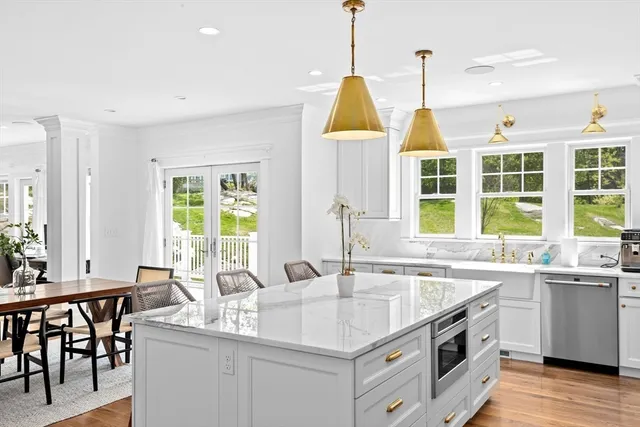 a kitchen with stainless steel appliances granite countertop a sink and a wooden floors