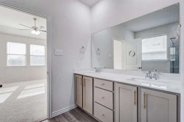 a bathroom with a granite countertop sink mirror and double