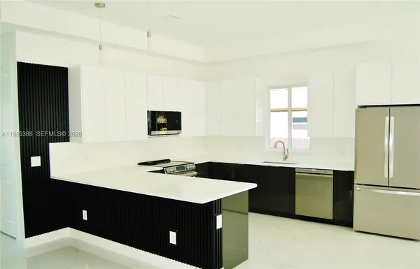 a kitchen with a sink and a refrigerator