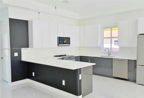 a kitchen with a sink cabinets and window