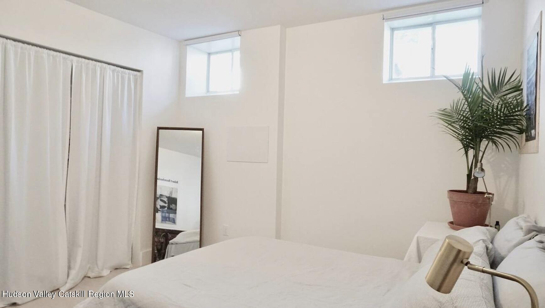 524 State Street Hudson, NY 12534 - Photo 6 of 8 a bedroom with a bed and a window