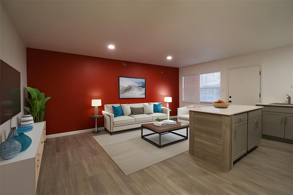 1722 Colquitt Street, Unit 4 Houston, TX 77098 - Photo 2 of 7 a living room with furniture a flat screen tv and a potted plant