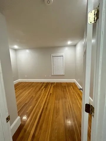 a view of a room with wooden floor