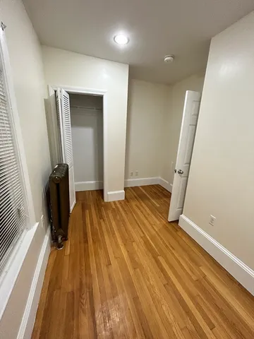 a view of a room with wooden floor and stairs