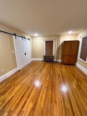 a view of a livingroom with wooden floor and staircase