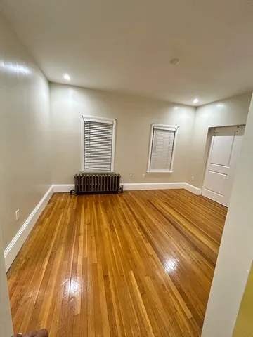 a spacious bedroom with a bed and a mirror