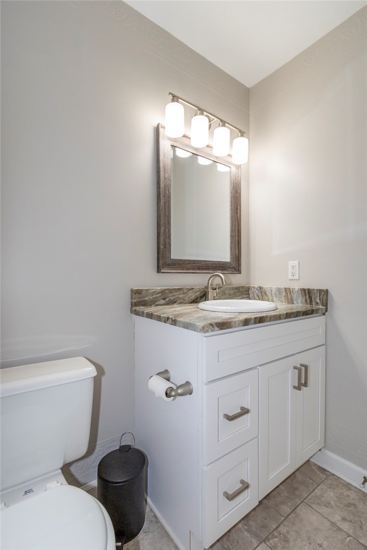 2509 Rolling Green Road Anderson, SC 29621 - Photo 20 of 28 Modern vanity with a granite countertop and contemporary fixtures elevate this clean bathroom space.