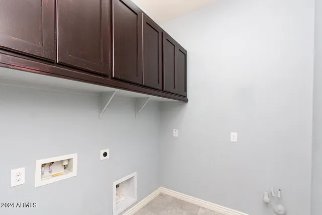 a view of storage and utility room with window